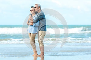 Asian Lifestyle senior couple hug on the beach happy in love romantic and relax time.